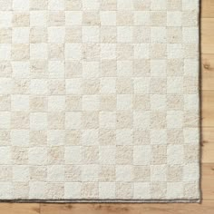 a white rug on top of a wooden floor