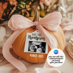 a baby announcement on a pumpkin with a pink bow