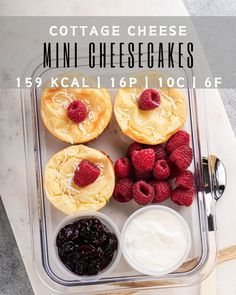 mini cheesecakes with raspberries and yogurt are on a tray