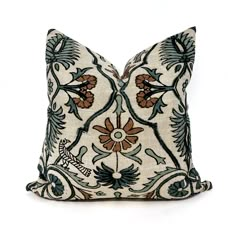 a decorative pillow with blue and brown flowers on it