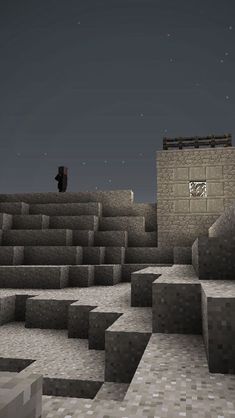 a man standing on top of a stone structure in the middle of a desert area