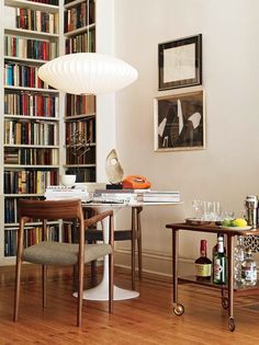 a living room filled with furniture and lots of books