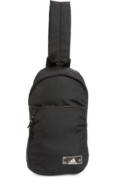 a black adidas backpack with the back strap hanging off it's side pocket