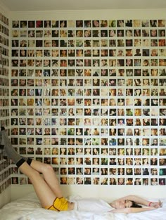 a woman standing in front of a wall covered with photos