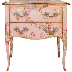 a pink floral chest with gold trimmings and flowers on the front, against a white background