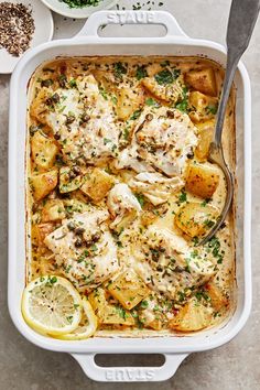 a casserole dish with chicken, potatoes and parsley on the side is ready to be eaten