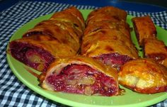 a green plate topped with pastries on top of a checkered table cloth