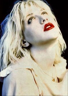 a woman with blonde hair and red lipstick