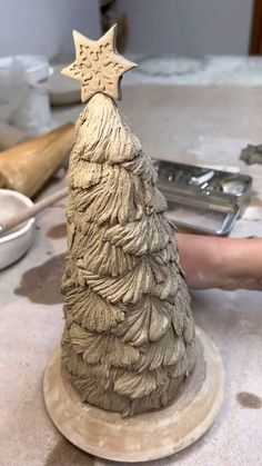 a clay christmas tree sitting on top of a table