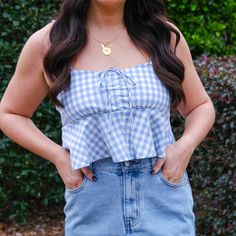 This charming gingham spaghetti strap tank top adds a fun and fresh touch to any outfit. The delicate spaghetti straps give it a feminine feel, perfect for warm days. Pair this tank with your favorite pair of white denim or a denim skirt for two trendy options. Summer Gingham Tops With Tie Straps, Spring Camisole With Spaghetti Tie Straps, Sleeveless Gingham Top With Tie Straps, Cute Summer Camisole With Adjustable Straps, Spring Sleeveless Tank Top For Picnic, Cute Summer Camisole With Spaghetti Straps, Cotton Tank Top With Tie Straps For Day Out, Cute Spaghetti Strap Camisole For Summer, Cute Spaghetti Straps Camisole For Summer