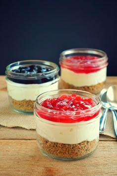 three desserts in small glass jars on a wooden table