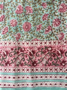 an image of a piece of cloth with flowers and vines on the side, in pink and green colors