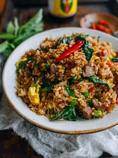 a white plate topped with fried rice and vegetables