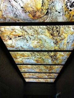 the ceiling is made up of many different colors and shapes, including golds and browns