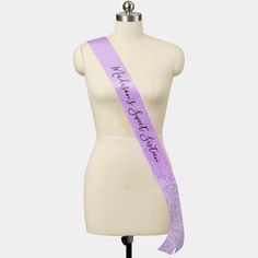 a mannequin with a purple sash on it