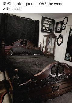 an old fashioned bed with black sheets and pillows