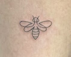 a bee tattoo on the back of a woman's stomach