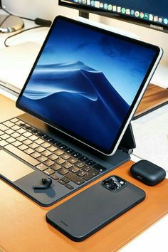 an open laptop computer sitting on top of a wooden desk next to a mouse and keyboard