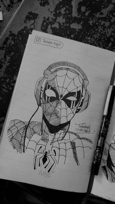 a drawing of spider - man with headphones on top of it and a pen next to it