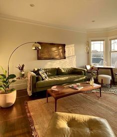 a living room filled with furniture and a large window covered in sun shining through the windows