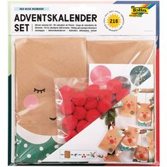 a package of christmas decorations with reindeers on the front and red pom - poms