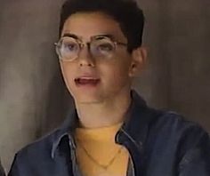 a woman wearing glasses and a yellow shirt