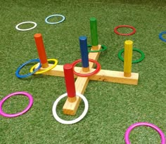 an outdoor play area with rings on the ground and grass in front of it that has been made out of wood