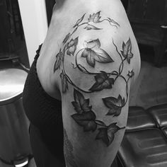 black and white photo of a woman's thigh with flowers on it