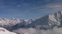 a man standing on top of a snow covered mountain