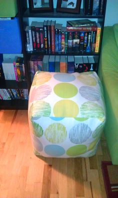 a chair that is sitting in front of a book shelf