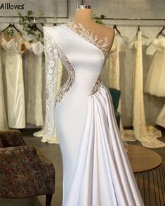 a white wedding dress on display in a store