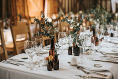 the table is set with wine glasses and bottles