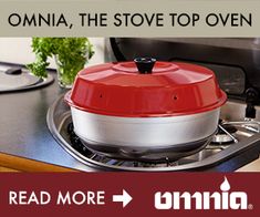 a red and white stove top oven sitting on top of a counter next to a pot