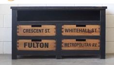 an old dresser with some wooden crates on it's sides and the words fulton written in black