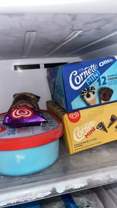 an open refrigerator filled with lots of food and confection items on top of each other