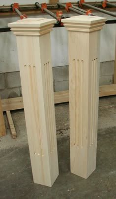 two tall wooden pillars sitting next to each other