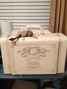 an old suitcase is sitting on a table