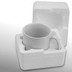 a white cup and saucer in a box