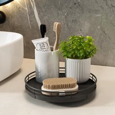 there is a toothbrush, brush and other items in the holder on the counter