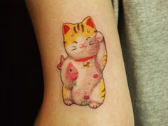 a cat and pig tattoo on the right arm, it looks like they are hugging each other