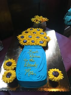 a blue cake with sunflowers on it