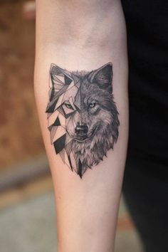 a black and white tattoo with a wolf head on the left arm, in geometric shapes