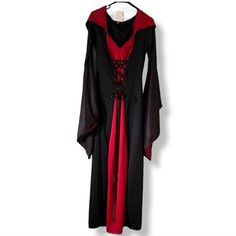 a black and red dress hanging on a hanger