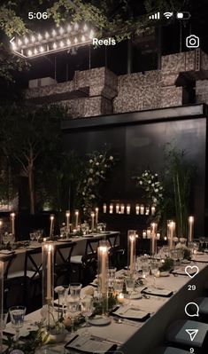 a table set up with candles and place settings