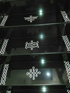 the glass shelves are decorated with intricate designs on them, and lit up at night