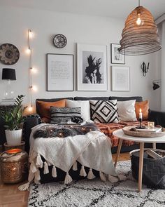 a living room filled with lots of furniture and pictures on the wall above it's coffee table