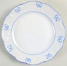 a blue and white plate with bows on it