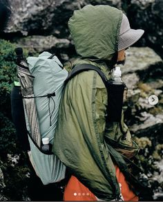 a person with a backpack and water bottle in their hands