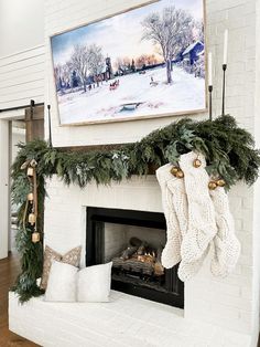 a fireplace decorated for christmas with stockings hanging from the mantle