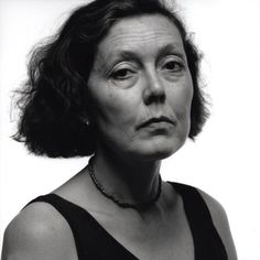 black and white photograph of an older woman looking at the camera with serious expression on her face